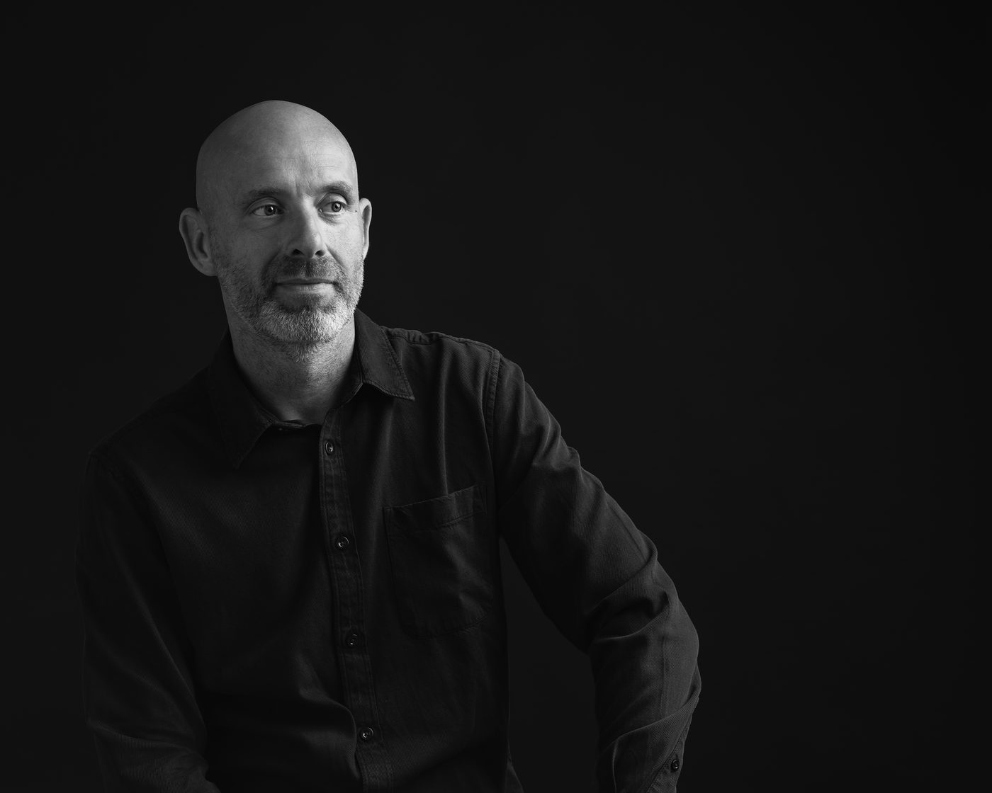 Mike Holden, black and white portrait in a dark shirt